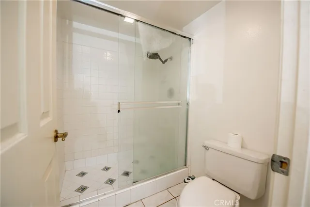 a bathroom with a shower and toilet