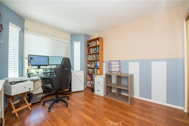 a view of a workspace with furniture and a window