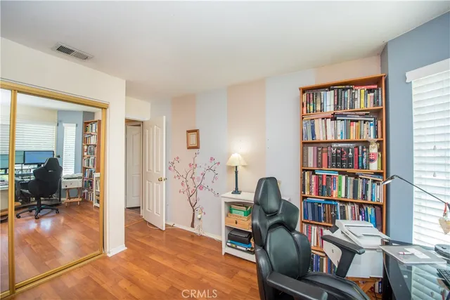 a living room with furniture and a book shelf