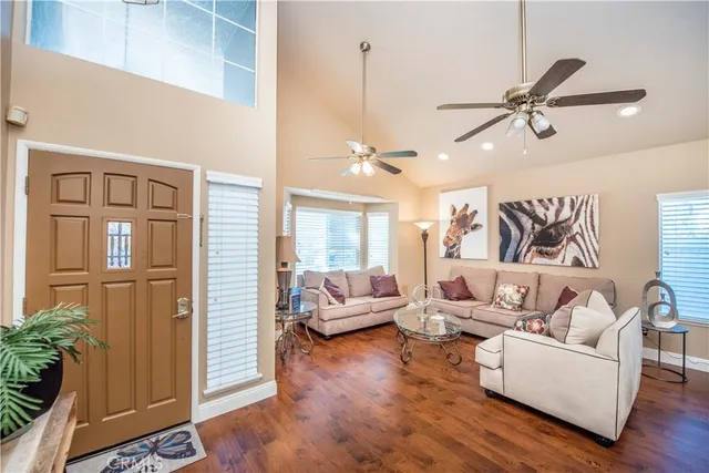 a living room with furniture and wooden floor
