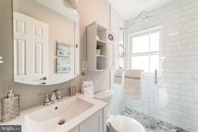 a bathroom with a sink toilet and shower
