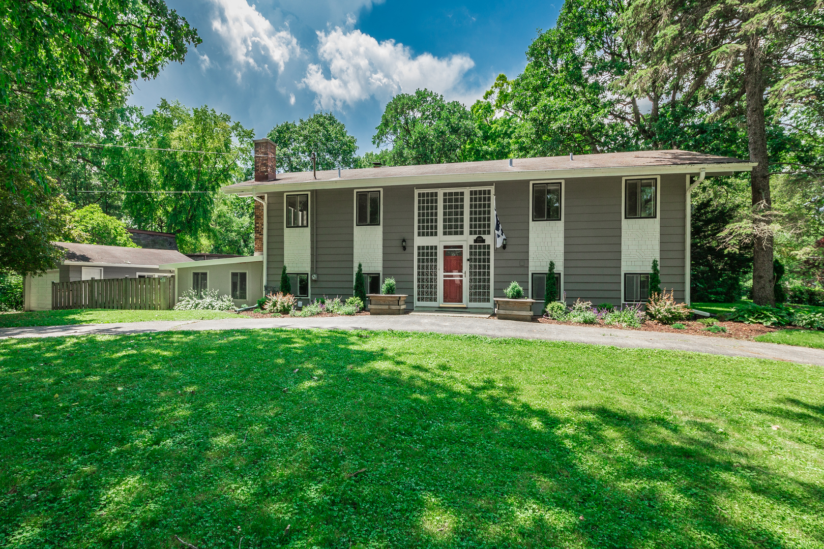 a front view of house with yard and green space
