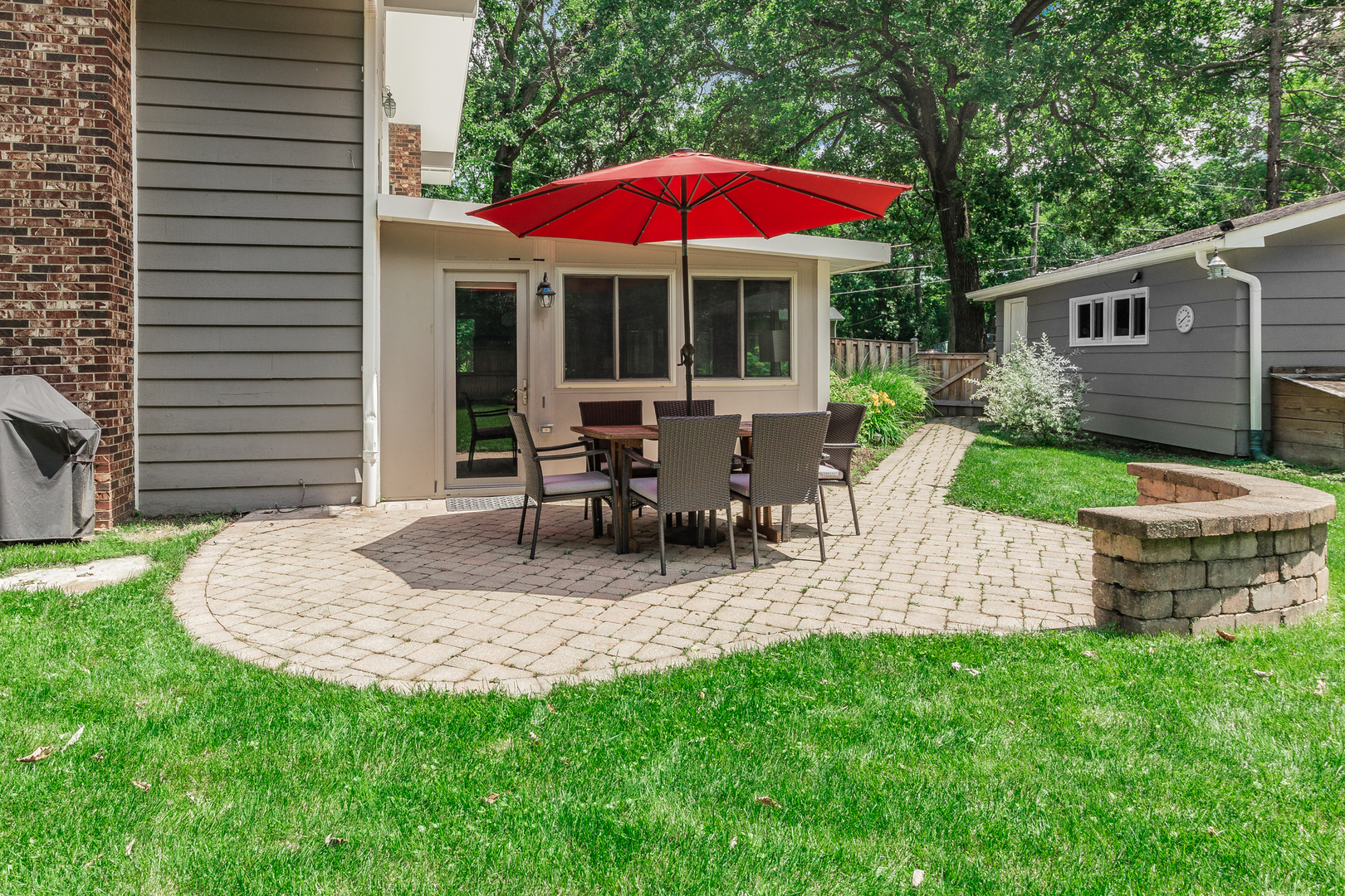 1440 Banbury Road Mundelein, IL 60060 - Photo 23 of 28 a view of a house with backyard sitting area and garden