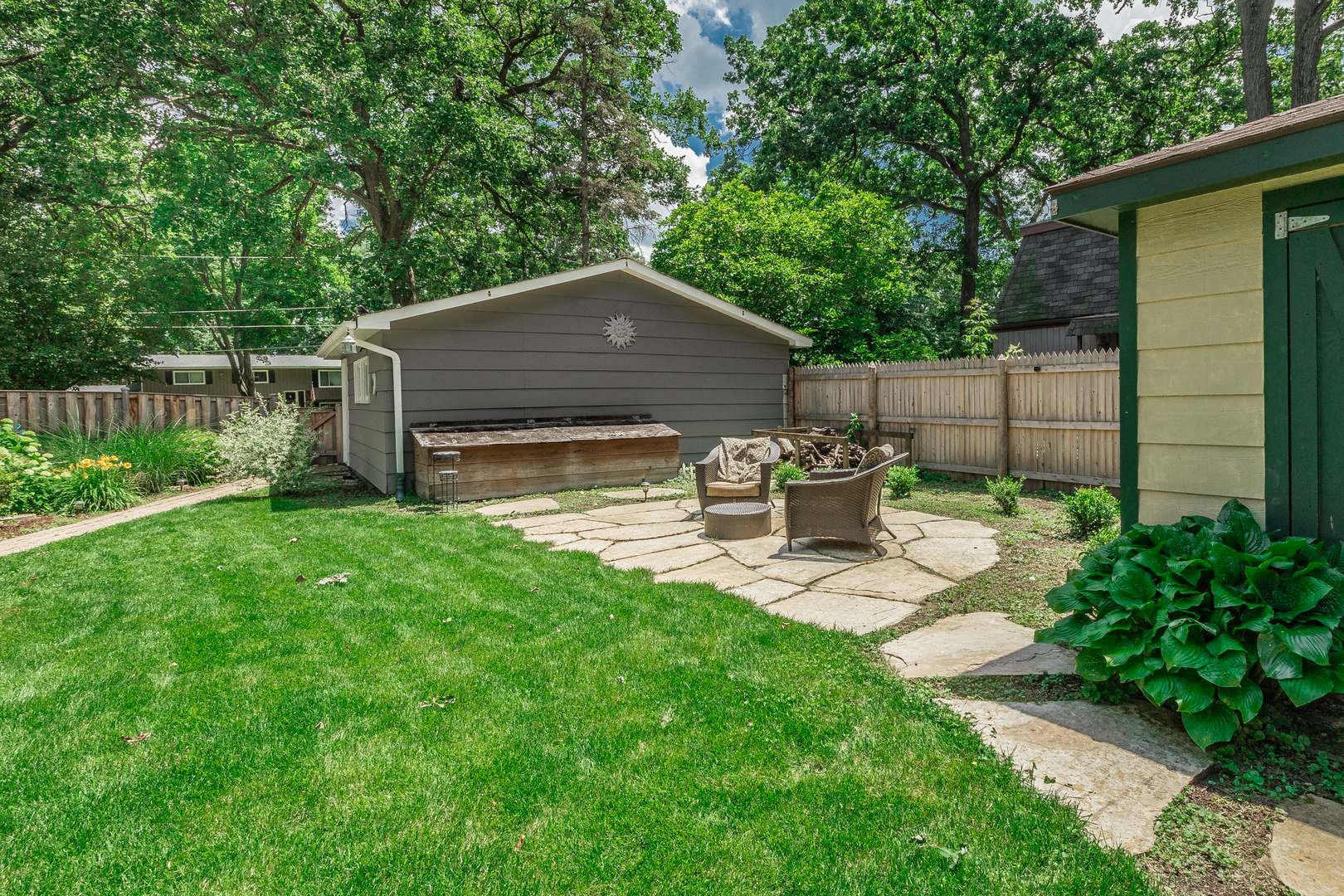 1440 Banbury Road Mundelein, IL 60060 - Photo 25 of 28 a view of a small yard and a wooden fence