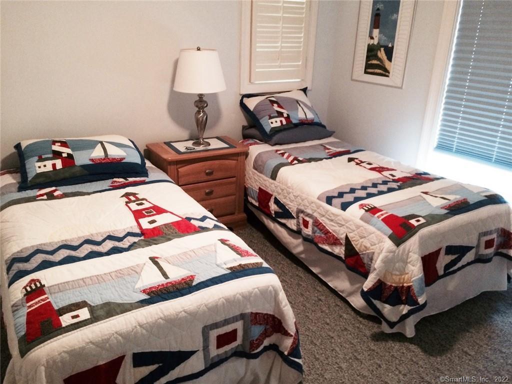 57 Harbor Avenue Madison, CT 06443 - Photo 12 of 16 a bedroom with two beds and a baby crib