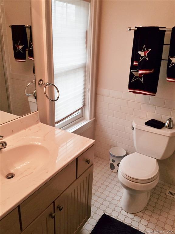 57 Harbor Avenue Madison, CT 06443 - Photo 13 of 16 a bathroom with a toilet sink and mirror