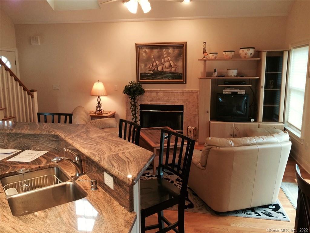 57 Harbor Avenue Madison, CT 06443 - Photo 2 of 16 a living room with furniture and a fireplace