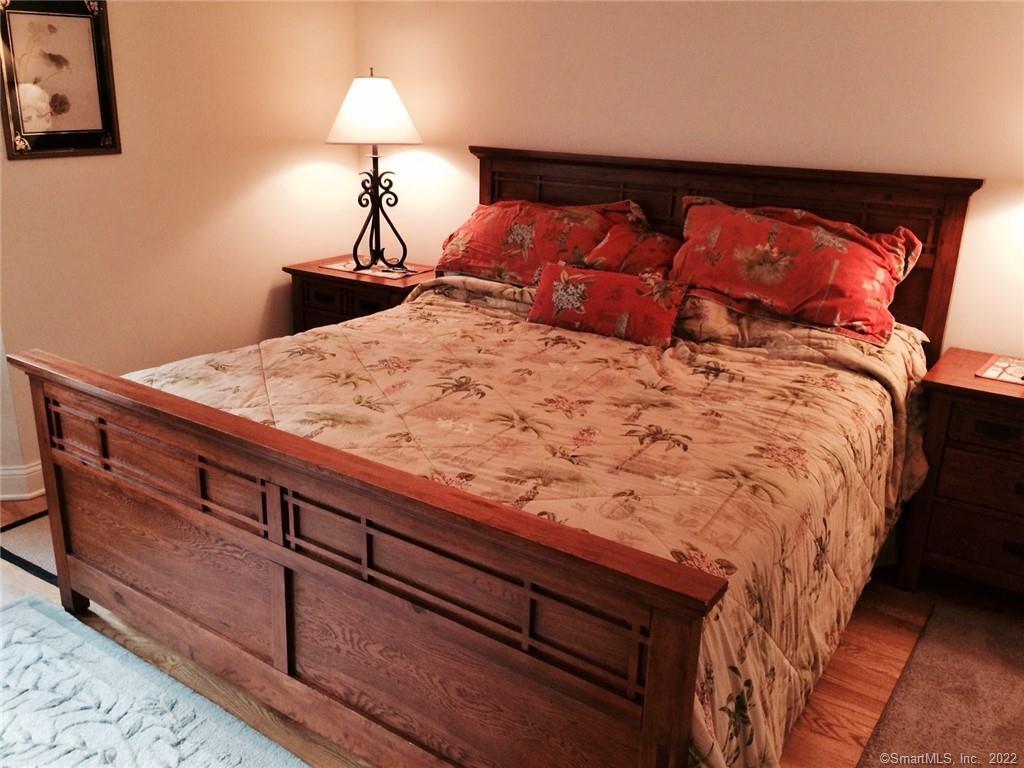 57 Harbor Avenue Madison, CT 06443 - Photo 8 of 16 a bedroom with a bed and a lamp