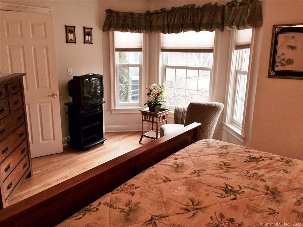 57 Harbor Avenue Madison, CT 06443 - Photo 9 of 16 a bedroom with a bed and wooden floor