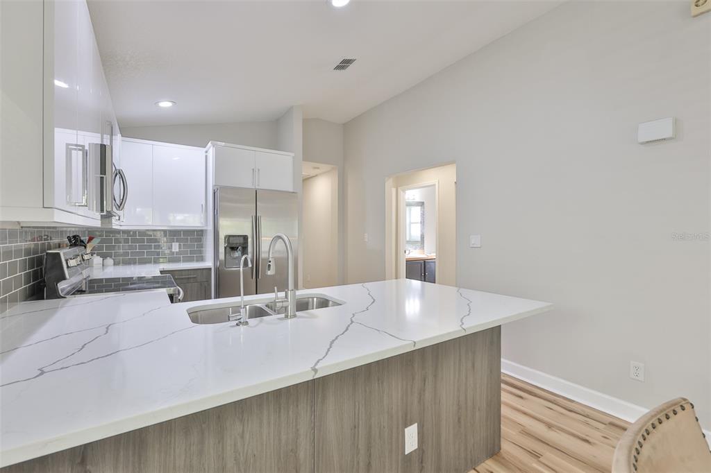 2331 West Chestnut Street Tampa, FL 33607 - Photo 13 of 34 a large kitchen with stainless steel appliances a large counter top and sink