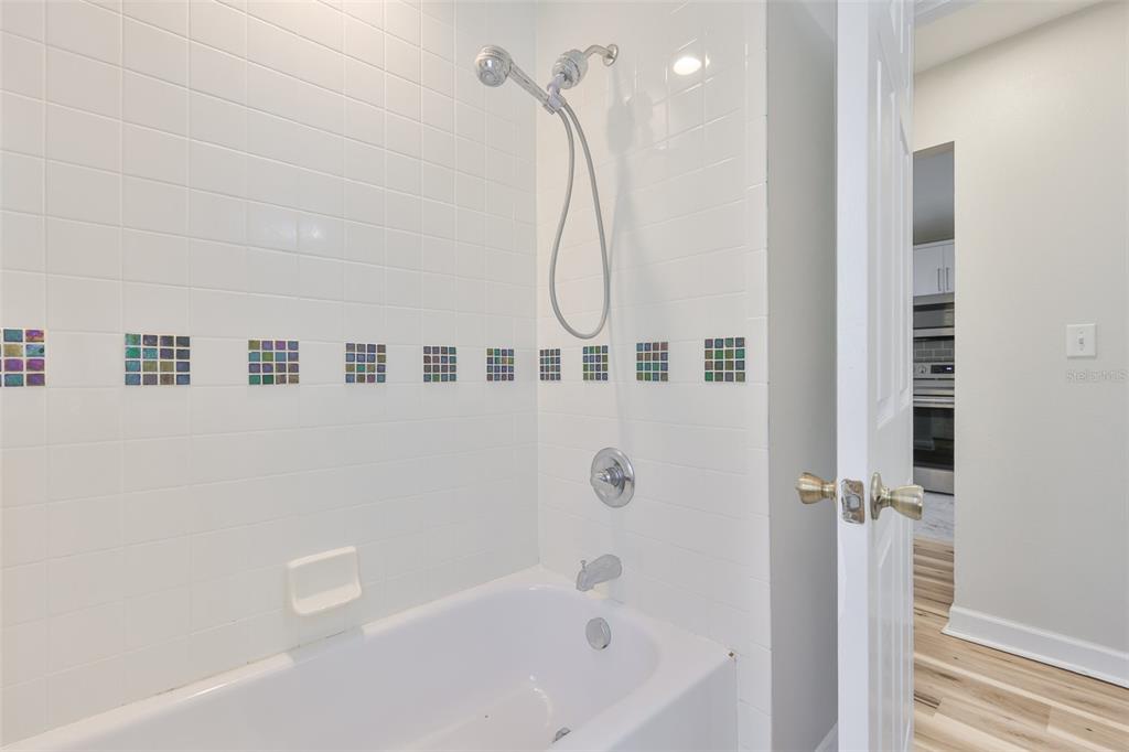 2331 West Chestnut Street Tampa, FL 33607 - Photo 24 of 34 a bathroom with a bathtub a shower and a shower