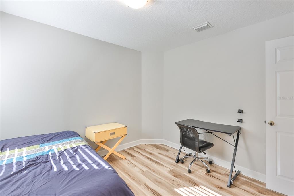 2331 West Chestnut Street Tampa, FL 33607 - Photo 26 of 34 a bedroom with a bed and a chair