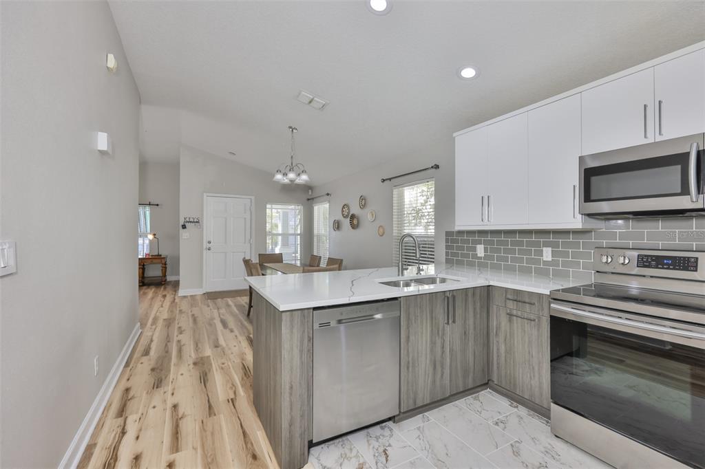 2331 West Chestnut Street Tampa, FL 33607 - Photo 5 of 34 a kitchen with a sink stove and microwave