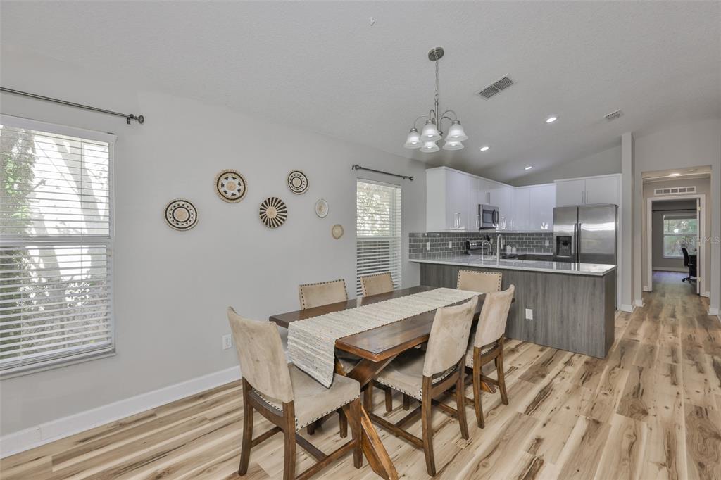 2331 West Chestnut Street Tampa, FL 33607 - Photo 6 of 34 a kitchen with granite countertop white cabinets and refrigerator
