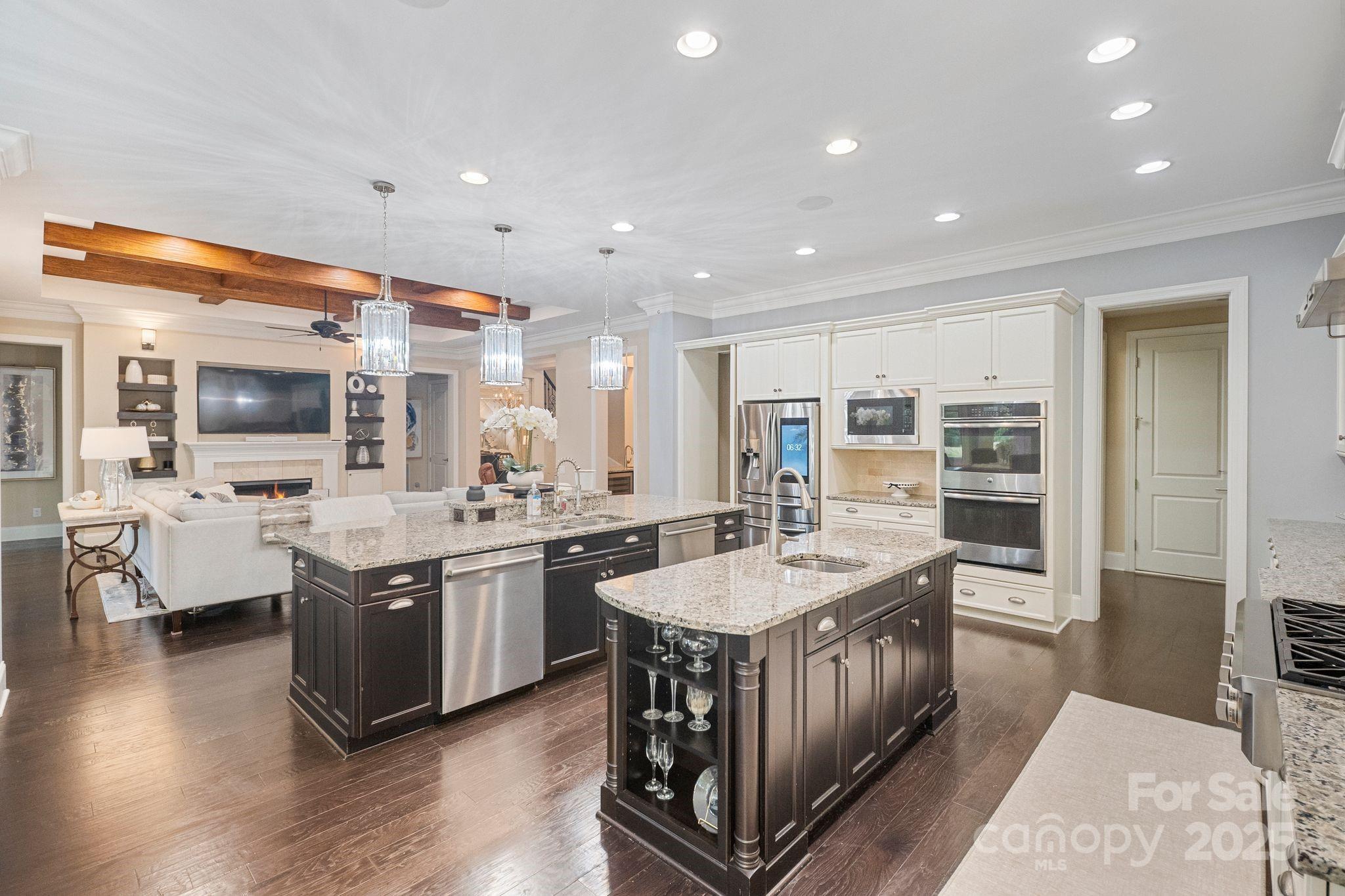 2051 Brawley School Road Mooresville, NC 28117 - Photo 19 of 47 a large kitchen with stainless steel appliances a sink and cabinets