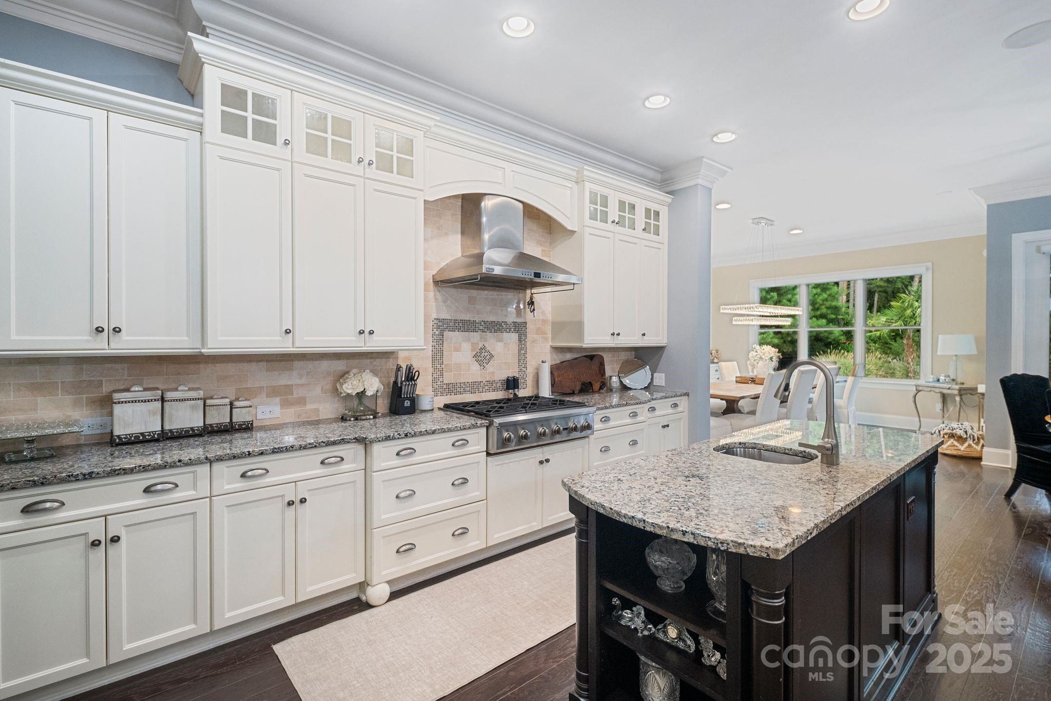 2051 Brawley School Road Mooresville, NC 28117 - Photo 20 of 47 a kitchen with granite countertop stainless steel appliances a sink and cabinets