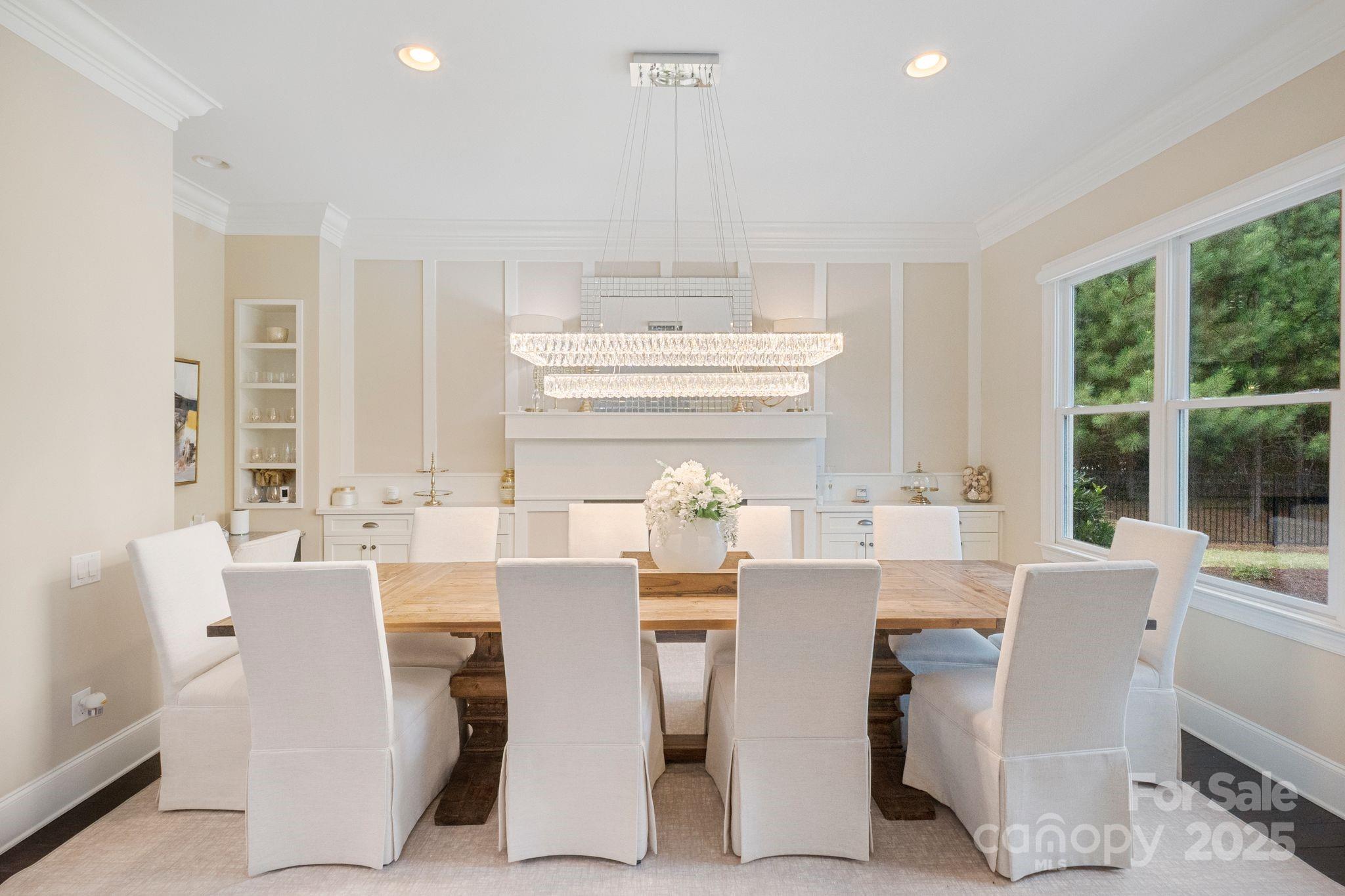 2051 Brawley School Road Mooresville, NC 28117 - Photo 23 of 47 a dining room with furniture a large window and a chandelier