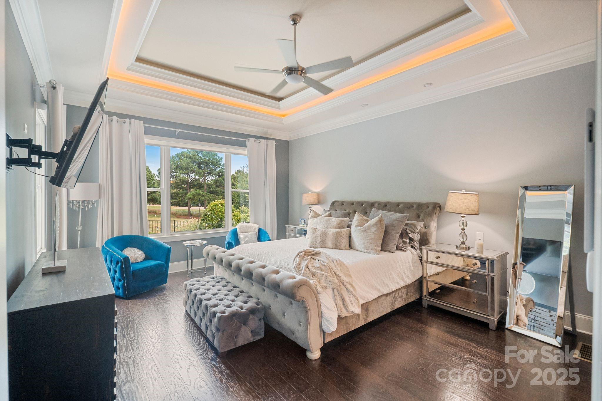 2051 Brawley School Road Mooresville, NC 28117 - Photo 24 of 47 a bedroom with a bed and a chandelier