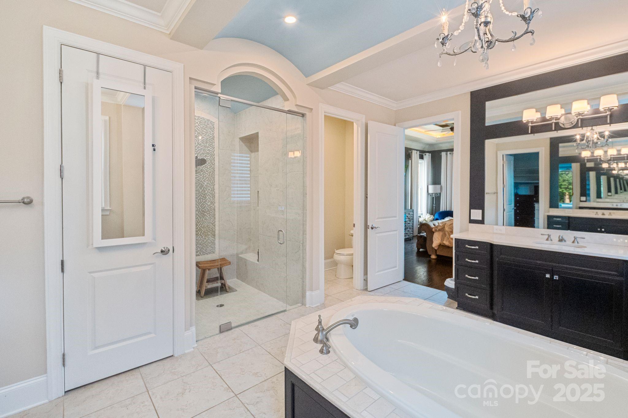 2051 Brawley School Road Mooresville, NC 28117 - Photo 26 of 47 a spacious bathroom with a tub sink shower and mirror