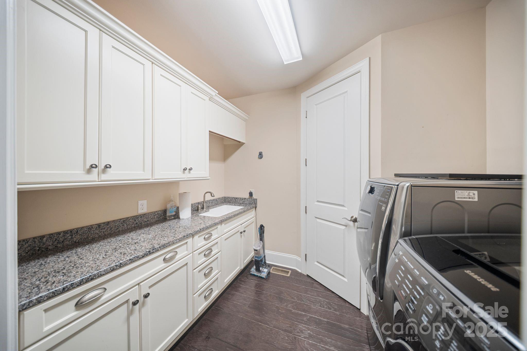 2051 Brawley School Road Mooresville, NC 28117 - Photo 28 of 47 a kitchen with a sink stove and cabinets