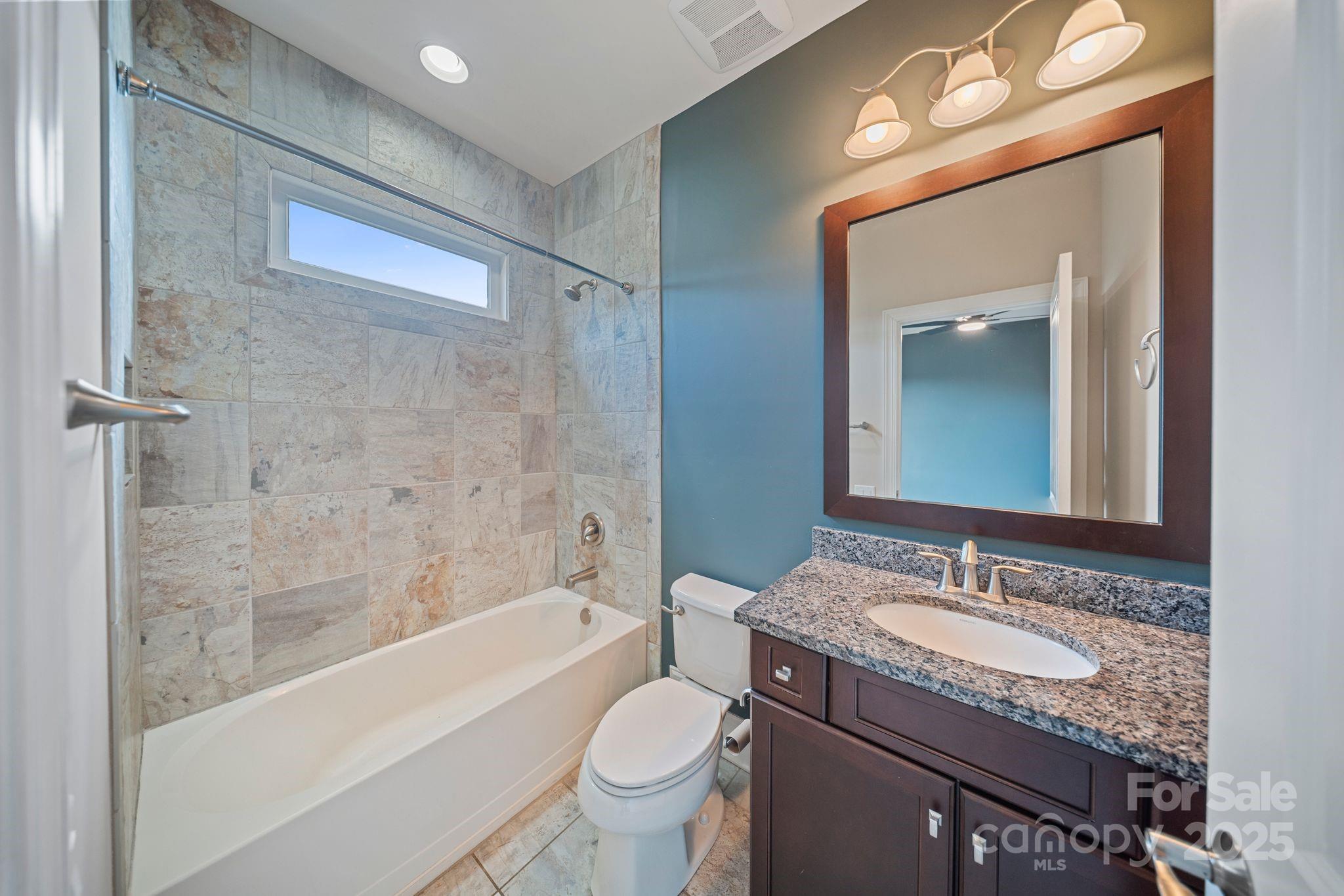 2051 Brawley School Road Mooresville, NC 28117 - Photo 32 of 47 a bathroom with a granite countertop sink a toilet and bathtub