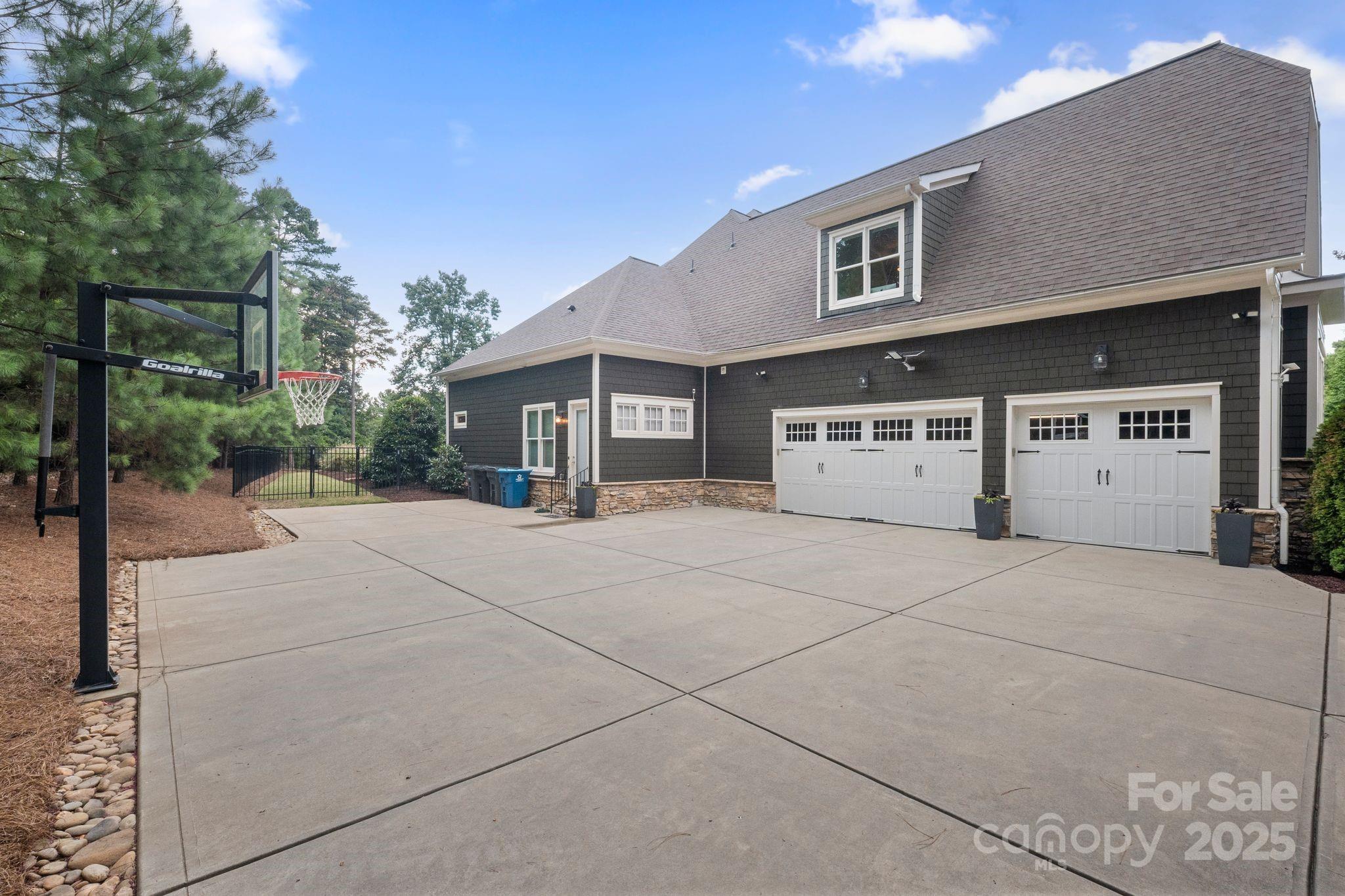 2051 Brawley School Road Mooresville, NC 28117 - Photo 10 of 47 a front view of a house with a yard and garage