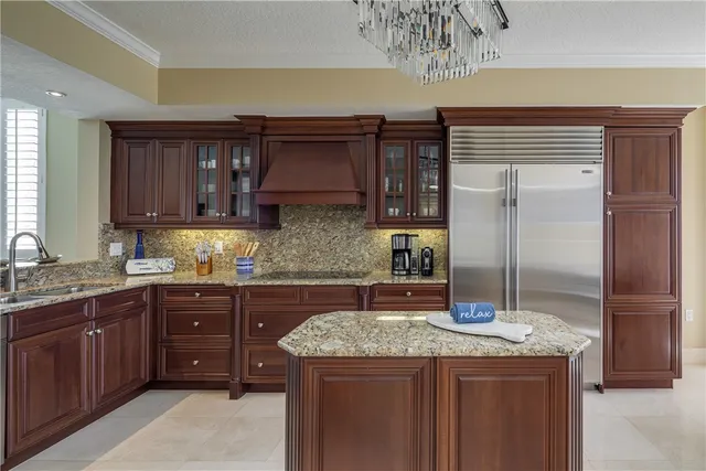 a kitchen with a sink a refrigerator and cabinets
