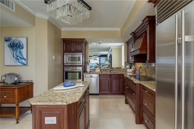 a kitchen with stainless steel appliances granite countertop a stove refrigerator and cabinets