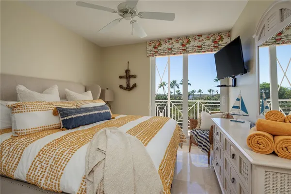 a bedroom with two beds and a flat screen tv