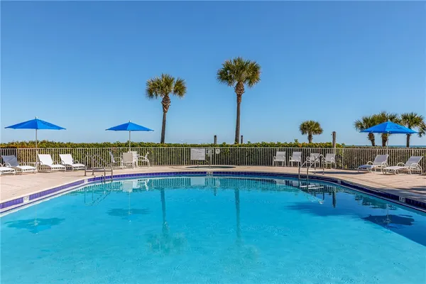a view of a swimming pool and an outdoor seating