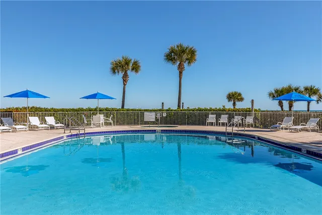 a view of a swimming pool and an outdoor seating