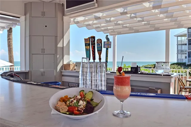 a view of a balcony with chairs and wooden floor
