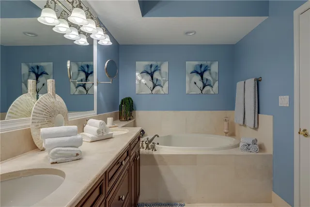a bath tub sitting next to a white sink