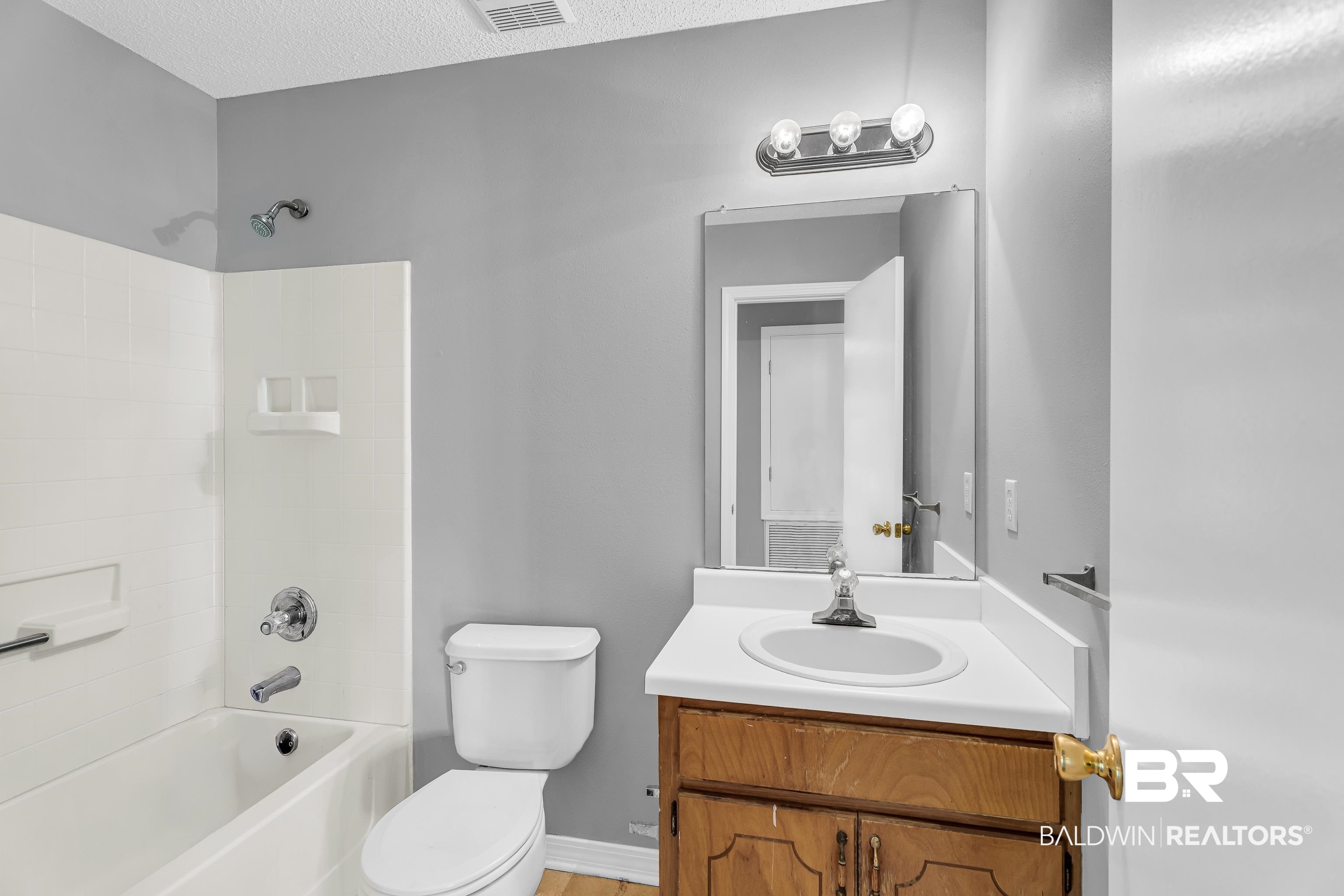 7787 Bellingrath Road Theodore, AL 36582 - Photo 20 of 36 Bathroom with shower / washtub combination, vanity, and a textured ceiling