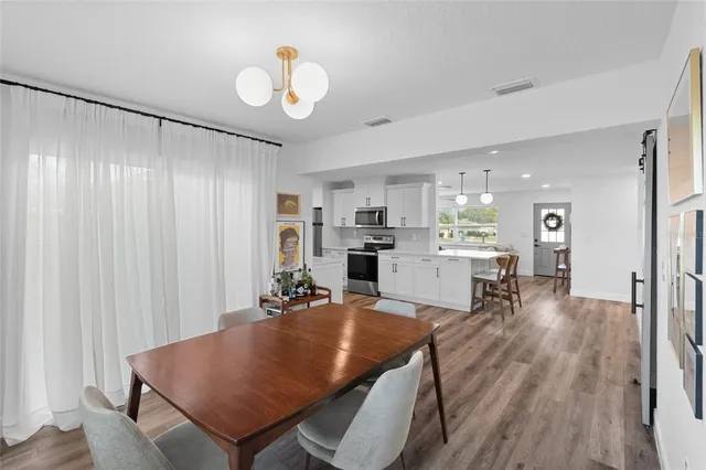 a living room with furniture and kitchen view