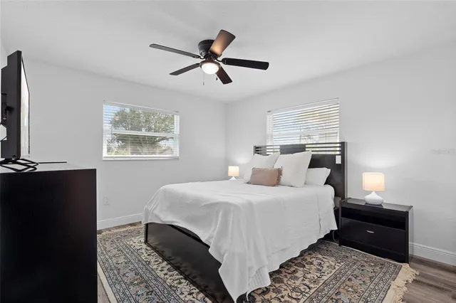 a bedroom with a bed and wooden floor