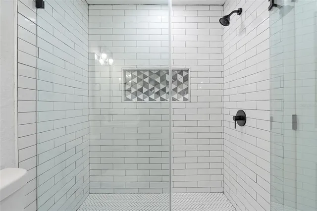 a living room with furniture a flat screen tv and a ceiling fan