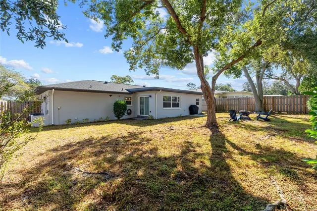 a view of a house with snow on the side of the road