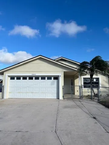 a view of a house with a backyard