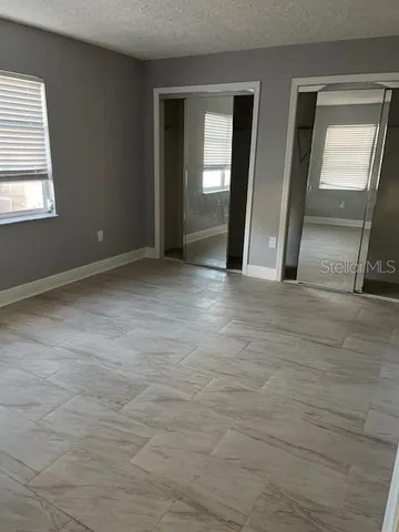 a view of an empty room with glass door