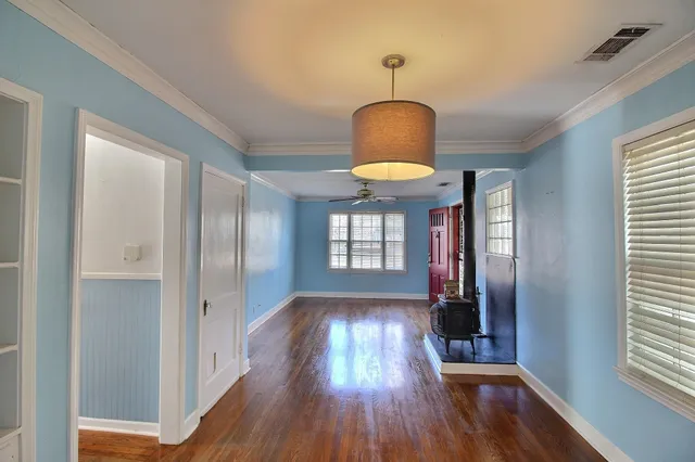 a view of hallway with wooden floor and chandelier