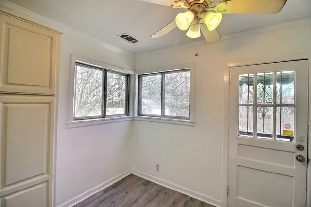 a view of an entryway with wooden floor