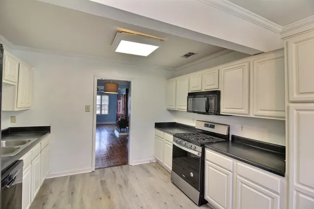a kitchen with stainless steel appliances granite countertop a stove and a refrigerator