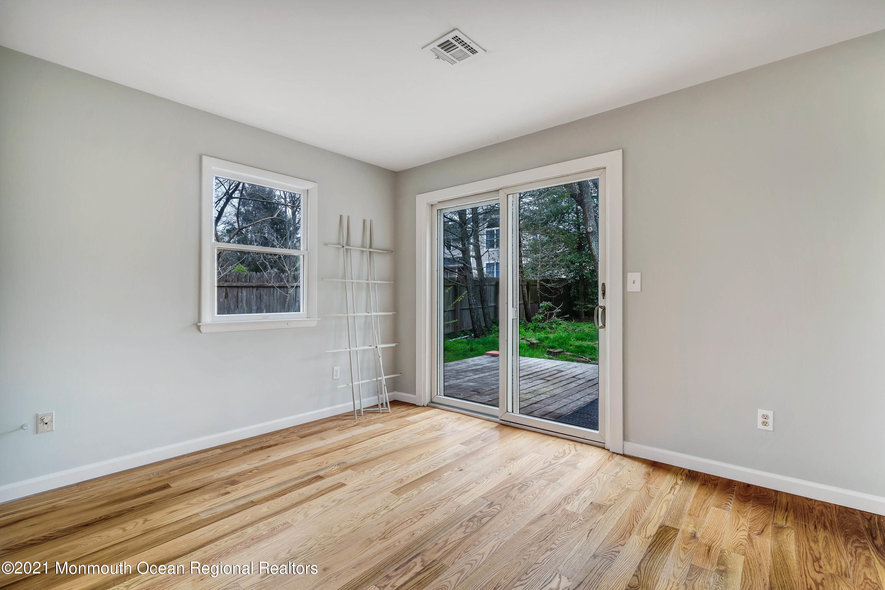 237 Cherry Quay Road Brick, NJ 08723 - Photo 11 of 21 a view of an empty room with wooden floor and a window