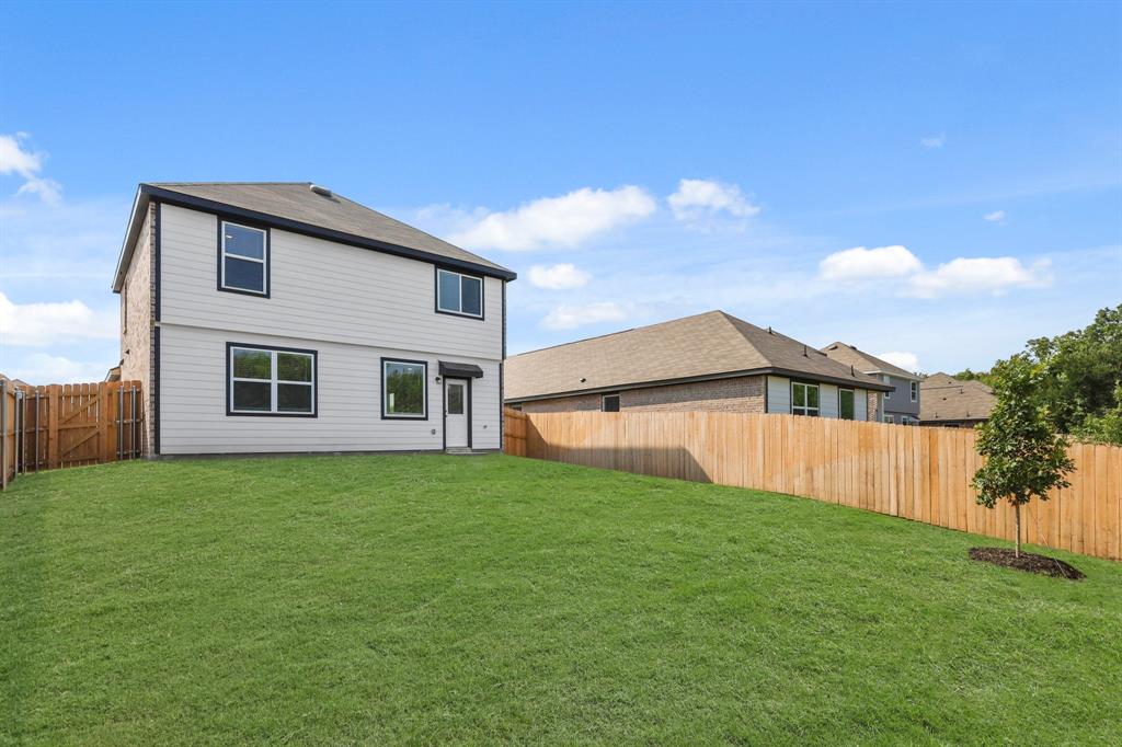 1510 Romans Road Ennis, TX 75119 - Photo 17 of 40 a view of a yard in front of a house with plants and large tree