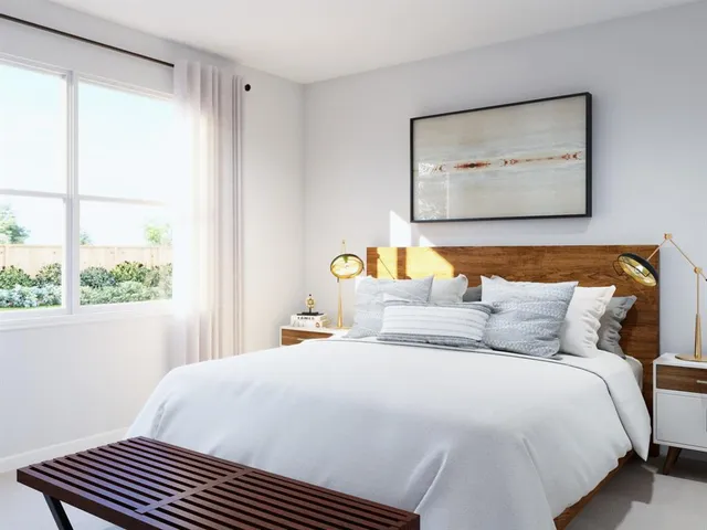 a bedroom with a bed and a dresser