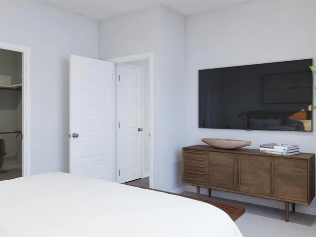 a view of walk in closet with empty racks