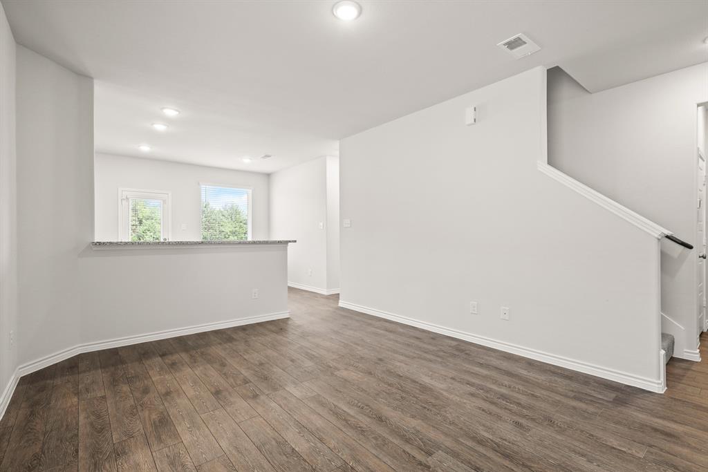 1510 Romans Road Ennis, TX 75119 - Photo 3 of 40 an empty room with wooden floor and windows