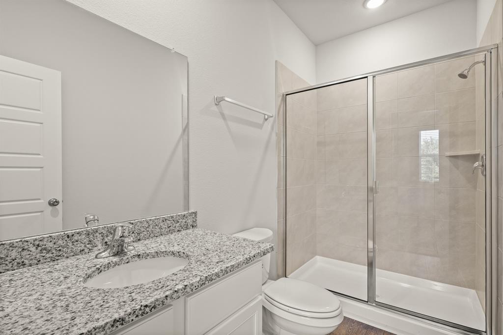 1510 Romans Road Ennis, TX 75119 - Photo 8 of 40 a bathroom with a granite countertop sink toilet and shower