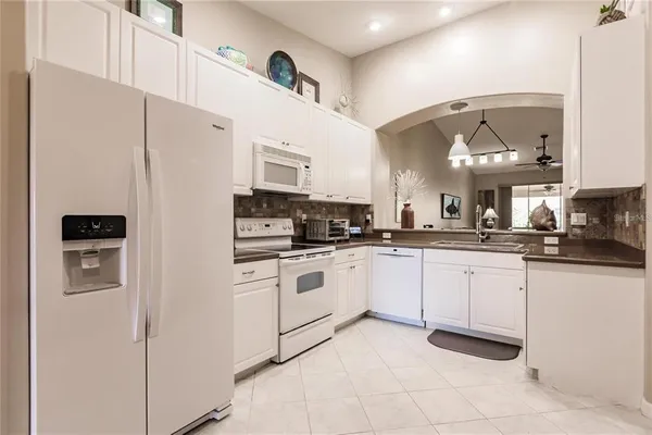 a kitchen with stainless steel appliances granite countertop a refrigerator and a stove